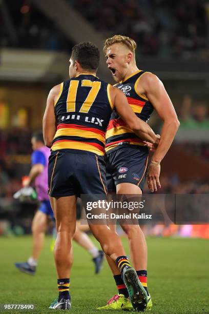 Curly Hampton of the Crows and Hugh Greenwood of the Crows celebrate during the round 15 AFL match between the Adelaide Crows and the West Coast...