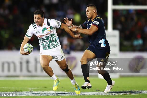 During the round 17: Anton Lienert-Brown of the Chiefs fends off Tevita Li of the Highlanders during the Super Rugby match between the Highlanders...