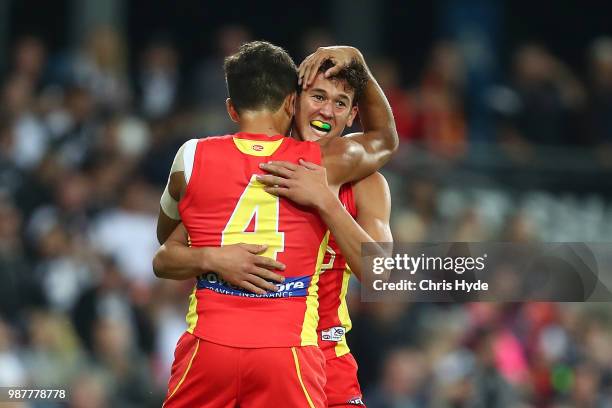 Wil Powell of the Suns celebrates his first goal during the round 15 AFL match between the Gold Coast Suns and the Collingwood Magpies at Metricon...