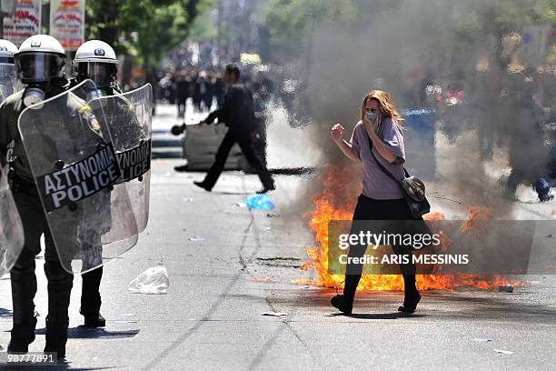 Demonstrator tries to avoid a petrol bomb during clashes between police and demonstrators in central Athens on May 1, 2010. Clashes erupted when...
