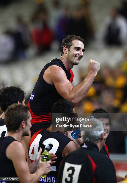 Jobe Watson of the Bombers celebrates while being chaired off after his 100th match after the round six AFL match between the Essendon Bombers and...