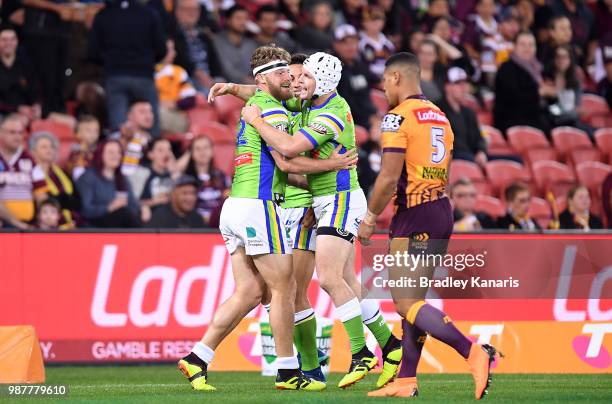 Elliott Whitehead of the Raiders is congratulated by team mates after scoring a try during the round 16 NRL match between the Brisbane Broncos and...