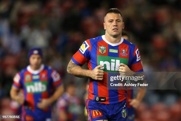 Shaun Kenny-Dowall of the Knights runs with his team during the round 16 NRL match between the Newcastle Knights and the Canterbury Bulldogs at...