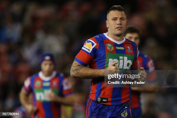 Shaun Kenny-Dowall of the Knights runs with his team during the round 16 NRL match between the Newcastle Knights and the Canterbury Bulldogs at...