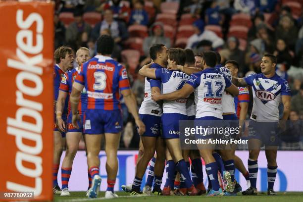 Bulldogs players celebrate a try during the round 16 NRL match between the Newcastle Knights and the Canterbury Bulldogs at McDonald Jones Stadium on...