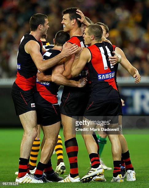 Essendon players congratulate David Hille on kicking a goal during the round 6 AFL match between the Essendon Bombers and the Hawthorn Hawks at...