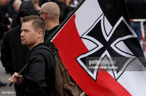 Neo-Nazi supporter arrives bearing colours of the pre-World War I German Empire at a rally and march on May 1, 2010 in Berlin, Germany. Several...