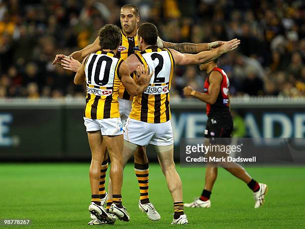 Hawthorn teammates celebrate a Lance Franklin goal during the round 6 AFL match between the Essendon Bombers and the Hawthorn Hawks at Melbourne...
