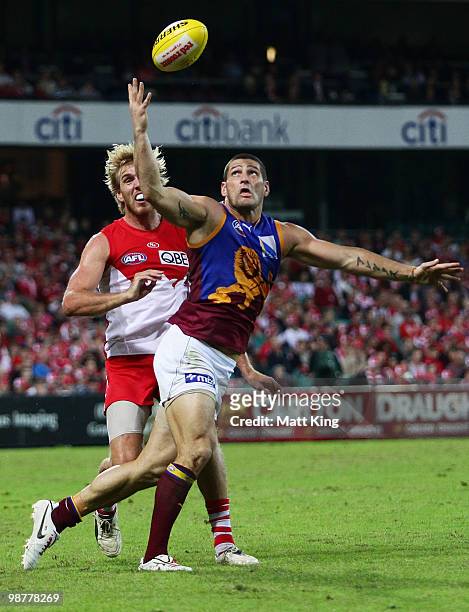 Brendan Fevola of the Lions juggles the ball in front of Lewis Roberts-Thomson of the Swans during the round six AFL match between the Sydney Swans...