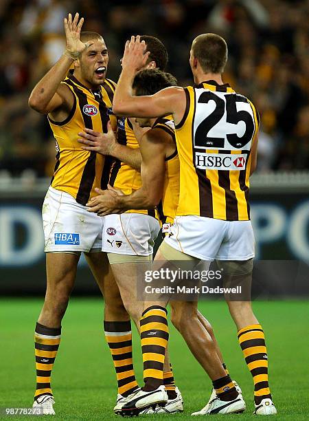 Hawthorn teammates celebrate a Lance Franklin goal during the round 6 AFL match between the Essendon Bombers and the Hawthorn Hawks at Melbourne...