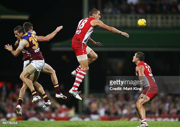 Jesse White of the Swans goes for a mark under pressure from Josh Drummond and Matt Austin of the Lions during the round six AFL match between the...