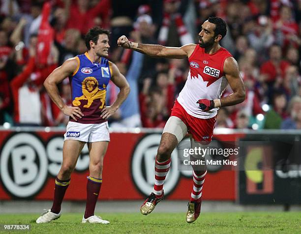 Adam Goodes of the Swans celebrates kicking a goal as Andrew Raines of the Lions looks on during the round six AFL match between the Sydney Swans and...