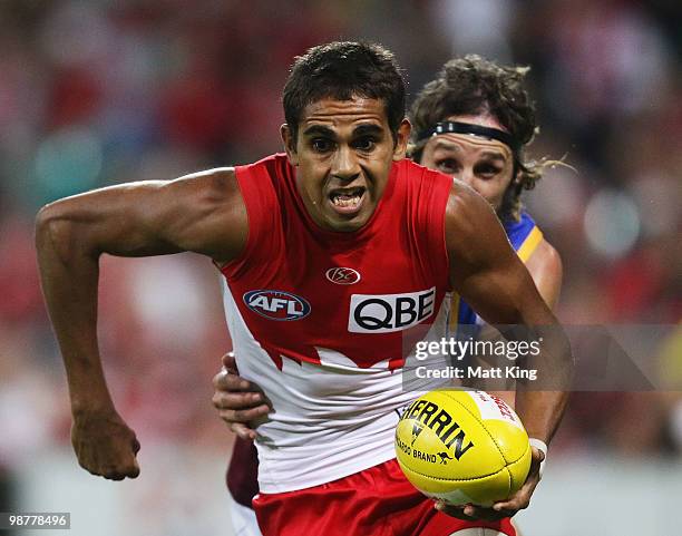 Lewis Jetta gets away from Travis Johnstone of the Lions during the round six AFL match between the Sydney Swans and the Brisbane Lions at the Sydney...