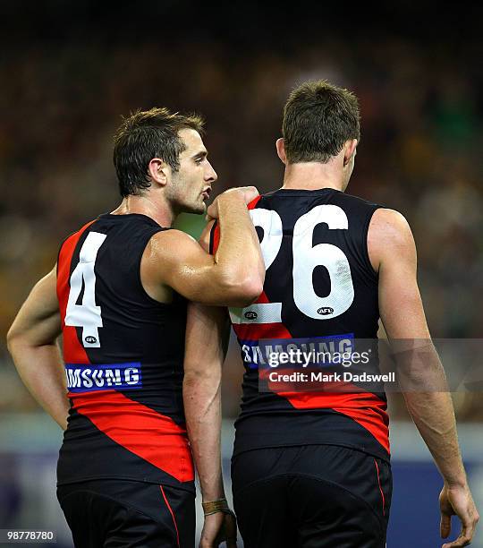 Jobe Watson has a quiet word with Cale Hooker of the Bombers during the round 6 AFL match between the Essendon Bombers and the Hawthorn Hawks at...
