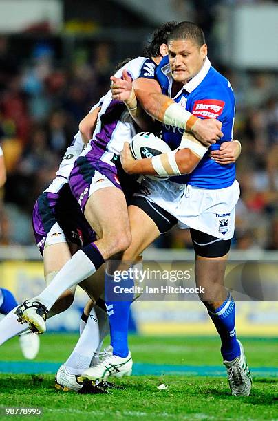 Willie Mason of the Cowboys looks to get through the Storm defence during the round eight NRL match between the North Queensland Cowboys and the...