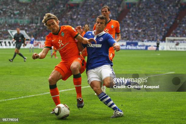 Lukas Schmitz challenges Clemens Fritz of Bremen during the Bundesliga match between FC Schalke 04 and SV Werder Bremen at Veltins Arena on May 1,...