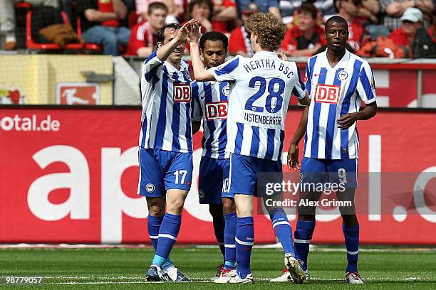 Raffael of Berlin celebrates his team's first goal with team mates Theofanis Gekas, Fabian Lustenberger and Adrian Ramos during the Bundesliga match...