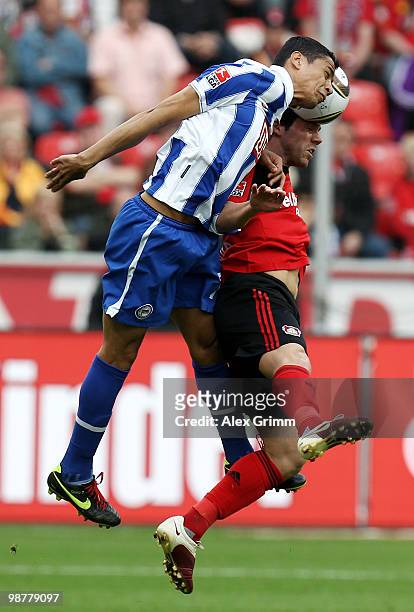 Cicero of Berlin jumps for a header with Gonzalo Castro of Leverkusen during the Bundesliga match between Bayer Leverkusen and Hertha BSC Berlin at...