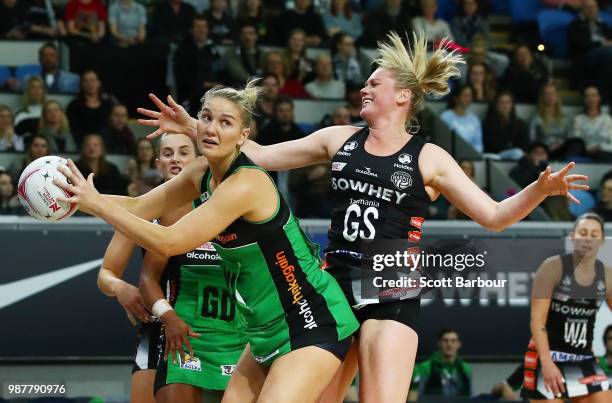 Caitlin Thwaites of the Magpies and Courtney Bruce of the Fever compete for the ball during the round nine Super Netball match between the Magpies...