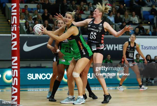 Caitlin Thwaites of the Magpies and Courtney Bruce of the Fever compete for the ball during the round nine Super Netball match between the Magpies...