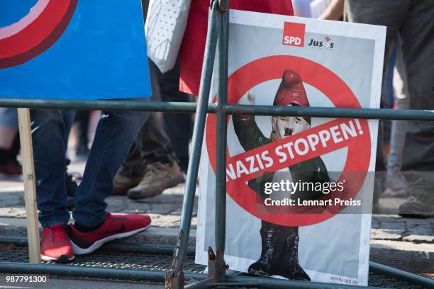 Protesters against the right-wing Alternative for Germany political party federal congress display a banner reading "Stop Nazis!" on June 30, 2018 in...
