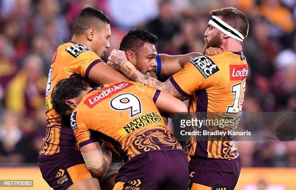 Dunamis Lui of the Raiders is tackled during the round 16 NRL match between the Brisbane Broncos and the Canberra Raiders at Suncorp Stadium on June...