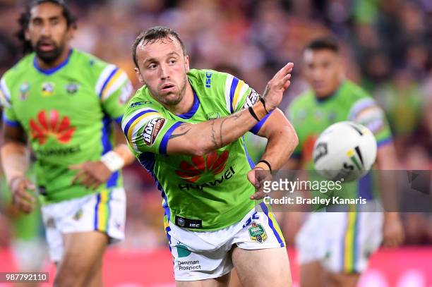 Josh Hodgson of the Raiders passes the ball during the round 16 NRL match between the Brisbane Broncos and the Canberra Raiders at Suncorp Stadium on...