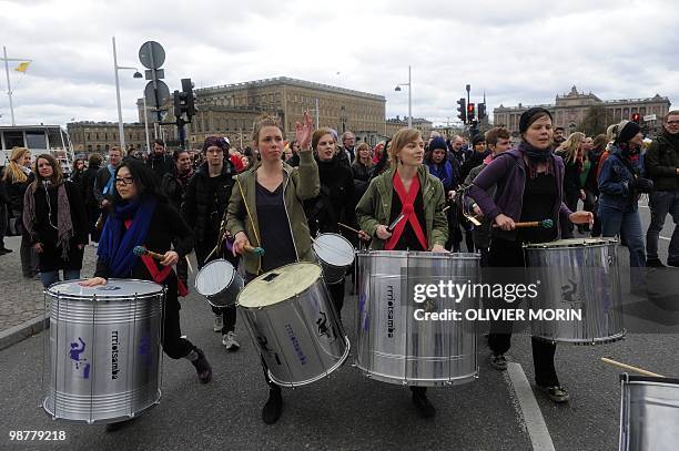 Demonstrators play the drums as they walk by the Royal Palace on May 1, 2010 in Stockholm during the Labour Day traditional rally gathering different...