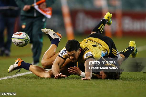 Nehe Milner-Skudder of the Hurricanes tackles Andy Muirhead of the Brumbies during the round 17 Super Rugby match between the Brumbies and the...