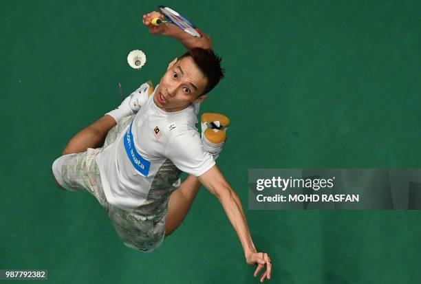 Lee Chong Wei of Malaysia smashes against Tommy Sugiarto of Indonesia in their men's singles semifinal match at the Malaysia Open Badminton...