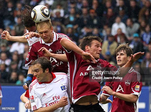 Marcus Berg of Hamburg and Andreas Wolf of Nuernberg compete for the ball during the Bundesliga match between Hamburger SV and 1. FC Nuernberg at HSH...