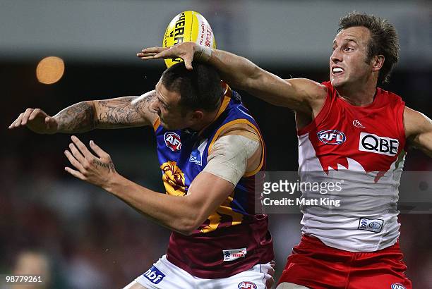 Jude Bolton of the Swans spoils a mark by Mitch Clark of the Lions during the round six AFL match between the Sydney Swans and the Brisbane Lions at...