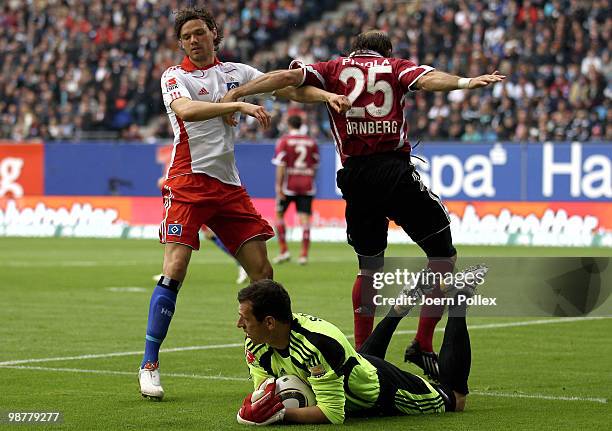 Marcus Berg of Hamburg competes for the ball with Javier Pinola and Raphael Schaefer of Nuernberg during the Bundesliga match between Hamburger SV...