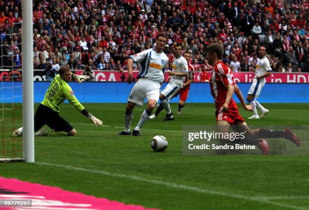 Thomas Mueller of Bayern scores the opening goal against goalkeeper Philipp Heerwagen of Bochum during the Bundesliga match between FC Bayern...