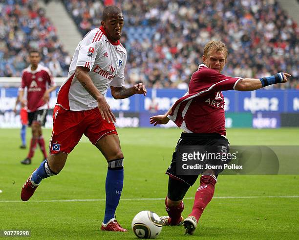 Jerome Boateng of Hamburg and Andreas Wolf of Nuernberg compete for the ball during the Bundesliga match between Hamburger SV and 1. FC Nuernberg at...