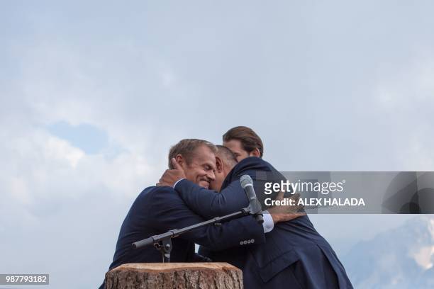 Bulgarian Prime Minister Boyko Borisov hugs President of the European Council Donald Tusk next to Austrian Chancellor Sebastian Kurz during a kick...