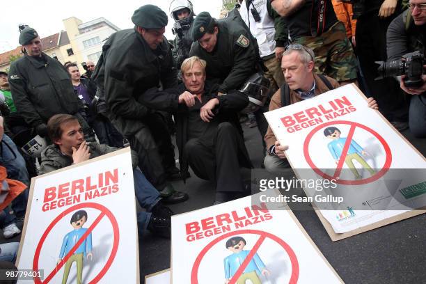Police lift away Guenter Piening, politician in the Berlin Senate, at a sit-in blockade where protesters tried to stop neo-Nazis from marching on May...