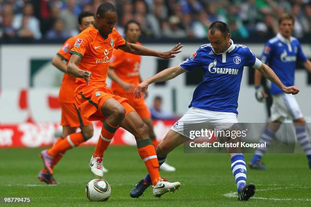 Heiko Westermann of Schalke challenges Naldo of Bremen during the Bundesliga match between FC Schalke 04 and SV Werder Bremen at Veltins Arena on May...