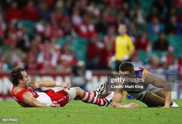 Jude Bolton of the Swans lies injured after a collision with Matt Maguire of the Lions during the round six AFL match between the Sydney Swans and...