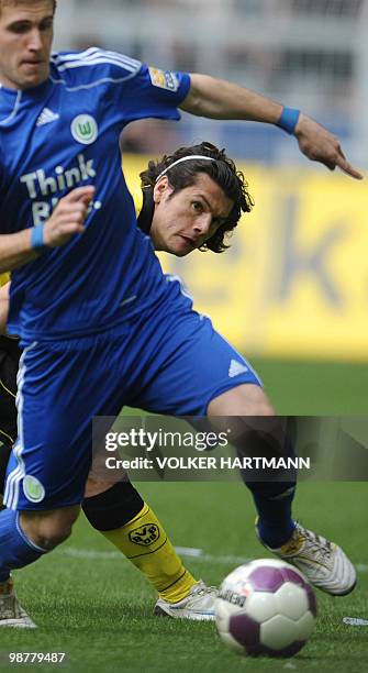 Wolfsburg's Slovakian defender Peter Pekarik and Dortmund's Paraguayan striker Nelson Valdez vie for the ball during the German first division...