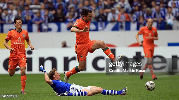 Benedikt Hoewedes of Schalke and Claudio Pizarro of Bremen battle for the ball during the Bundesliga match between FC Schalke 04 and Werder Bremen at...