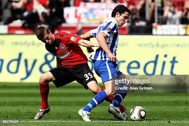 Gojko Kacar of Berlin is challenged by Toni Kroos of Leverkusen during the Bundesliga match between Bayer Leverkusen and Hertha BSC Berlin at the...