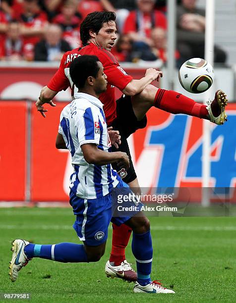 Gonzalo Castro of Leverkusen is challenged by Raffael of Berlin during the Bundesliga match between Bayer Leverkusen and Hertha BSC Berlin at the...