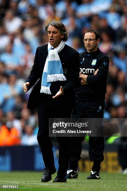 Roberto Mancini the Manchester City manager shouts instructions to his players as Martin O'Neill the Aston Villa manager looks on during the Barclays...