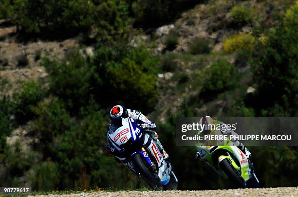 Fiat Yamaha Team's Spanish Jorge Lorenzo takes a curve followed by French Randy de Puniet during the Moto GP qualifying session at Jerez de la...
