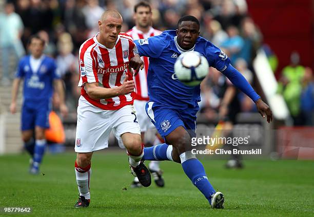 Victor Anichebe of Everton races for the ball with Andy Wilkinson of Stoke City during the Barclays Premier League match between Stoke City and...