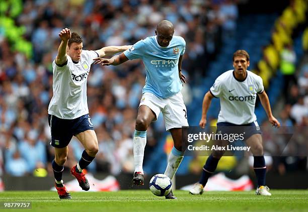 Patrick Vieira of Manchester City holds off the challenge from James Milner of Aston Villa during the Barclays Premier League match between...