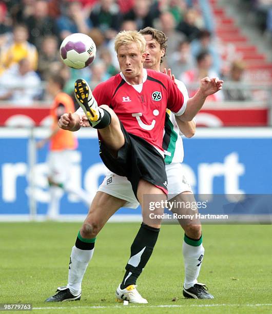 Mike Hanke of Hannover battles for the ball with Roel Brouwers of Moenchengladbach during the Bundesliga match between Hannover 96 and Borussia...