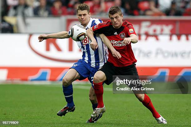 Toni Kroos of Leverkusen is challenged by Lukasz Piszczek of Berlin during the Bundesliga match between Bayer Leverkusen and Hertha BSC Berlin at the...