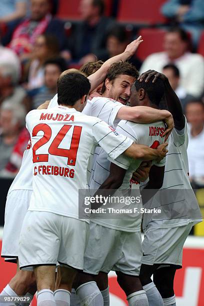 Heiko Butscher and Mohamadou Idrissou of Freiburg celebrate during the Bundesliga match between 1. FC Koeln and SC Freiburg at RheinEnergieStadion on...